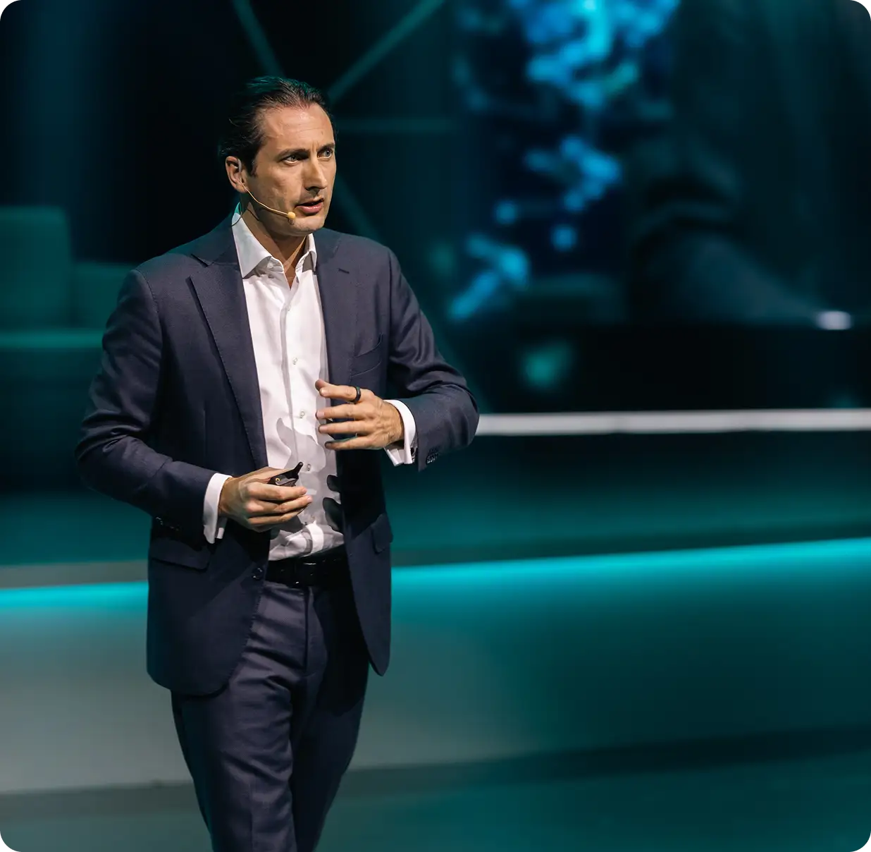 Business speaker presenting on stage during a conference about technology and innovation